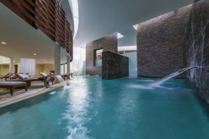 Grand Velas Riviera Maya spa with chaise lounges by pool