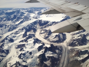 View out of airplane window of glaciers in Alaska