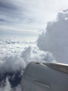 View out of airplane window of clouds
