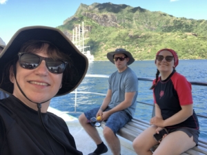 On a catamaran with the Wind Spirit in the background in Moorea