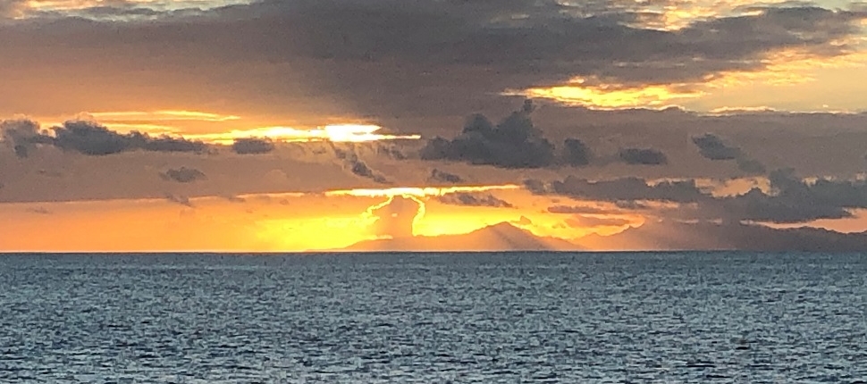 Sunset seen from Windstar cruise ship over island in the distance
